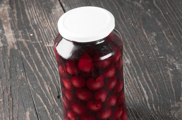 Cherry compote in a glass jar — Stock Photo, Image