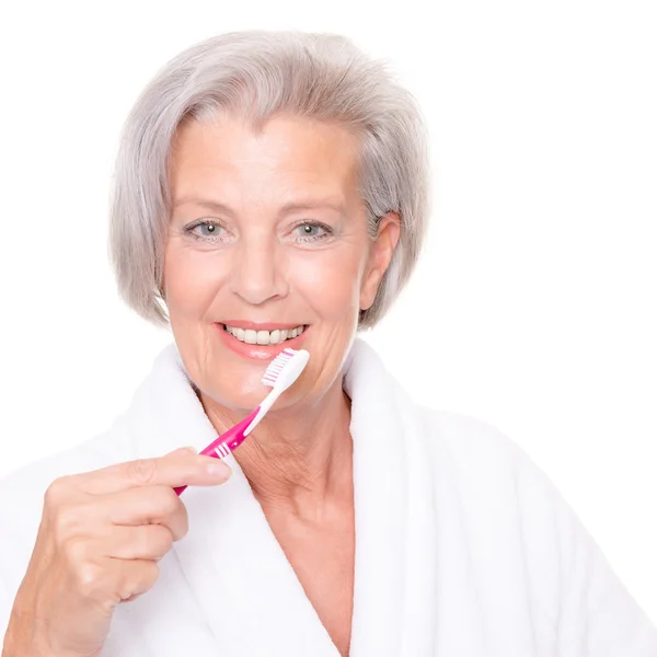 Starszy kobieta ze szczoteczka do zębów — Zdjęcie stockowe