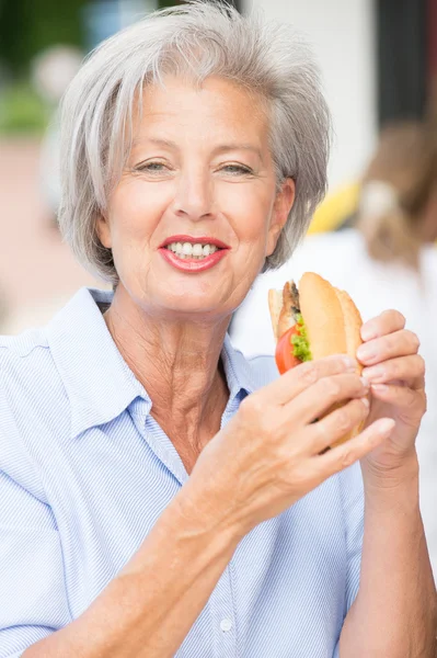 Senior woman eating — Stock Photo, Image
