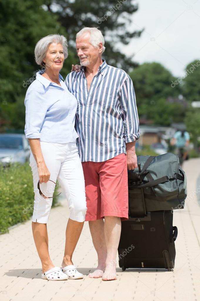 Senior couple with luggage