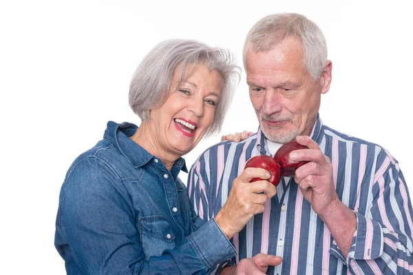 Senior couple with apple — Stock Photo, Image