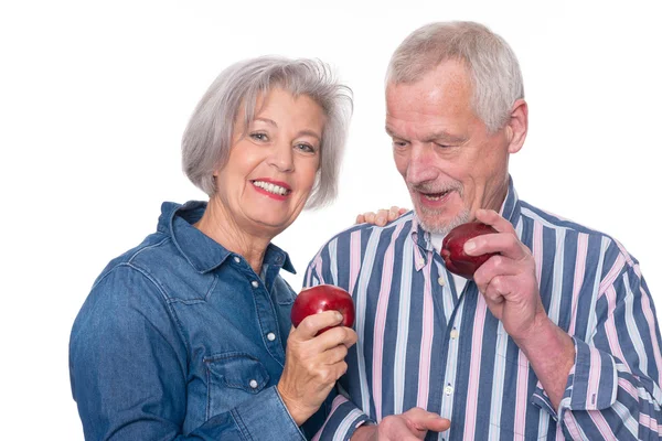 Senior couple with apple — Stock Photo, Image