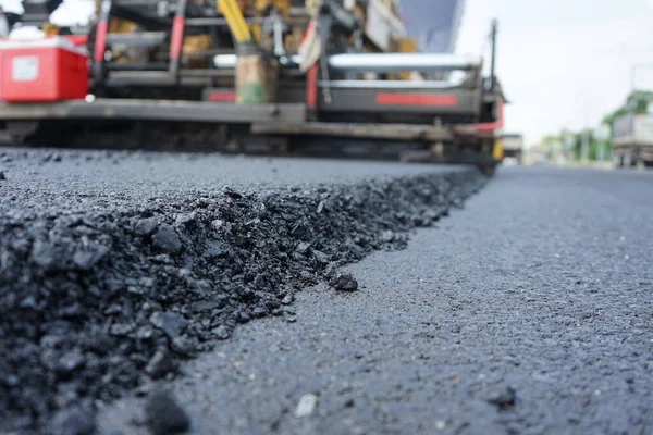 The image is blurred in the construction of paved roads. By heavy machinery