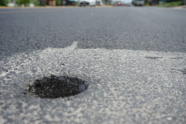 Holes from drilling to measure asphalt road thickness