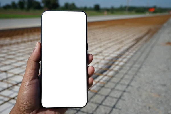 smartphone face blank add text Blurred background of road construction.