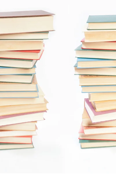 Two towers of books on white — Stock Photo, Image