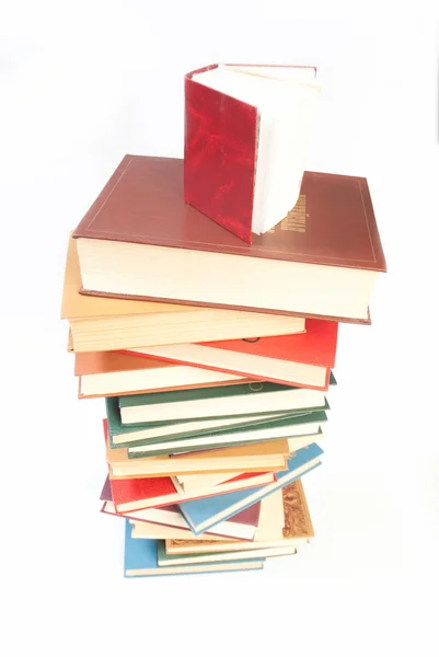 Pile of books with one book open — Stock Photo, Image