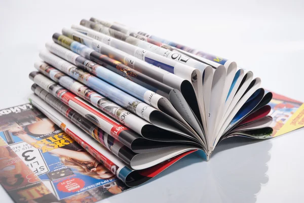 Open magazine with curled pages. Close-up — Stock Photo, Image