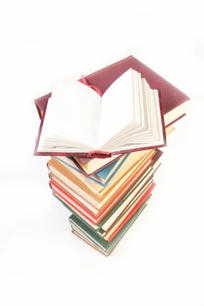 Pile of books with one book open — Stock Photo, Image