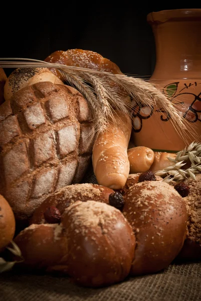 Assortment of baked bread on sacking — Stock Photo, Image