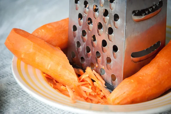 Carrot and grater for vegetables — Stock Photo, Image