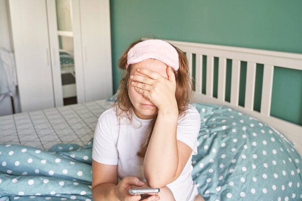 Pretty young woman texting by phone. Sad female person indoors. Business Lady