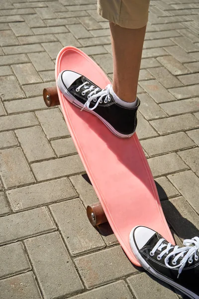 Ragazza con lo skateboard. Paesaggio urbano. Sneakers nere. Nuovo viaggio normale — Foto Stock