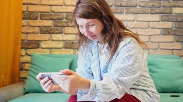 Pretty young woman texting phone. Sad female person indoors. Business portrait — Stock Video