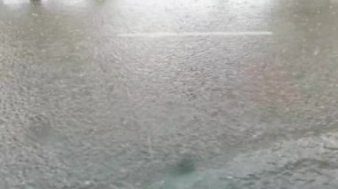 Şehir yağmuru. Büyük su birikintisi. Diğer tarafa bak. Sonbahar tehlikesi. Otomobil ıslak seyahat