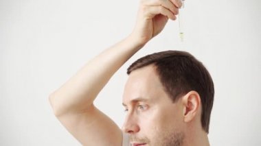 Young man hair treatment. Argan oil healthy massage. Morning bathroom routine