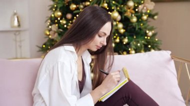 Young woman drawing neurographics indoors. Home vacation portrait