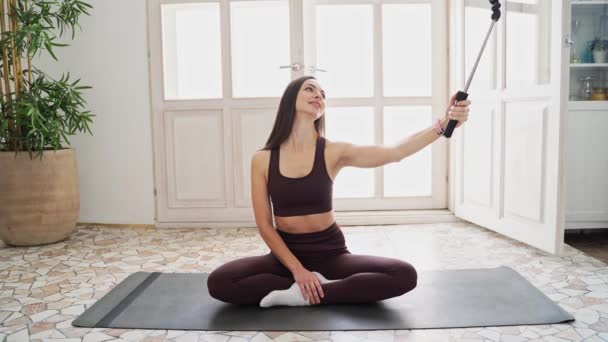 Młoda kobieta robi autoportret na macie do jogi. Portret z wakacji. Blogerka — Wideo stockowe
