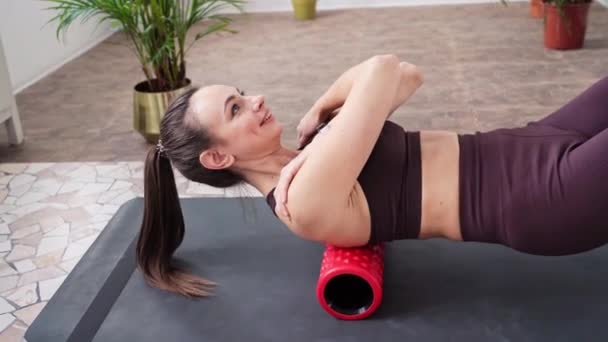 Young woman stretch body on fitness mat. Myofascial release massage. Relax