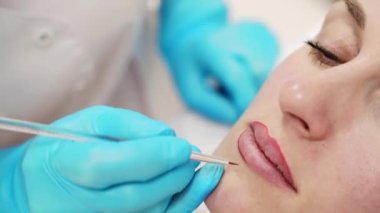 Permanent makeup. Beauty spa procedure. young woman. Face lip tattoo