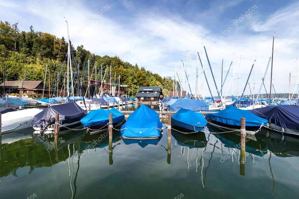 Yachts and boats at pier at the mountain lake