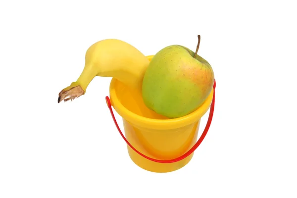 Apple and a banana in a bucket — Stock Photo, Image