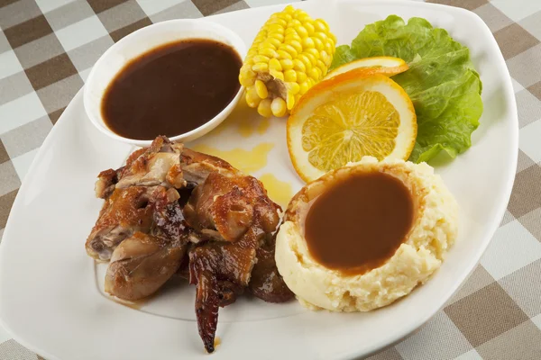 Chicken served with mashed potatos and gravy and a side of corn — Stock Photo, Image