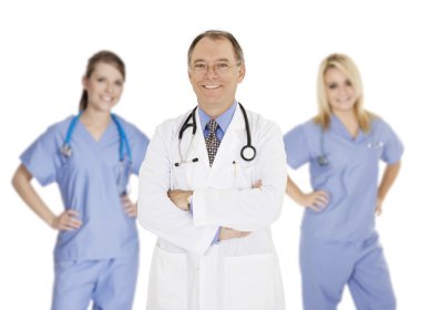A group of confident doctors and nurses with their arms crossed displaying some attitude and smiling isolated on a white background
