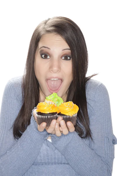 Beautiful Caucasian woman eating very unhealthy cupcakes — Stock Photo, Image