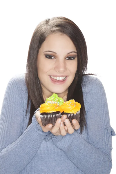 Beautiful Caucasian woman eating very unhealthy cupcakes — Stock Photo, Image