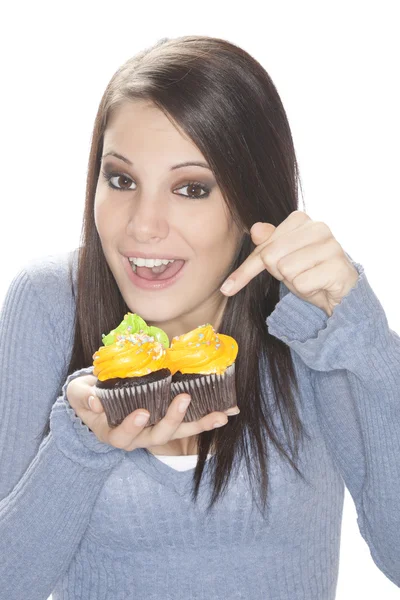 Beautiful Caucasian woman eating very unhealthy cupcakes — Stock Photo, Image