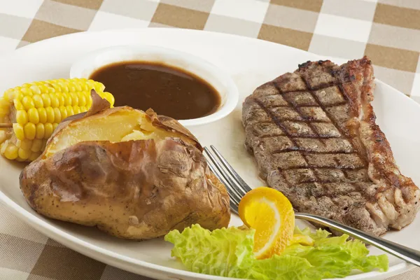 Deliicious grilled steak with baked potato and corn — Stock Photo, Image
