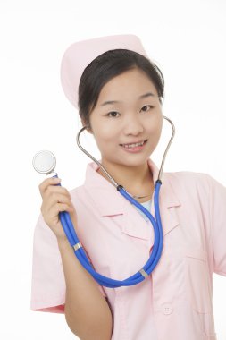 A portrait of a beautiful Asian nurse holding a stethoscope isolated on a white background