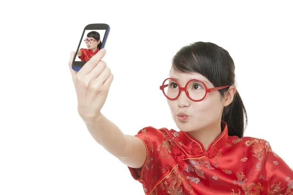 Schöne chinesische Frau trägt ein traditionelles Kleid, das als Chipao bekannt ist und macht ein Selfie von sich selbst isoliert auf weißem Hintergrund — Stockfoto