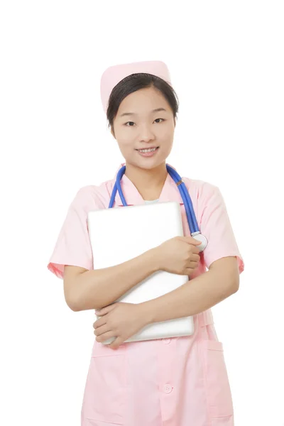 Beautiful Asian nurse holding a laptop computer isolated on a white background — Stok fotoğraf