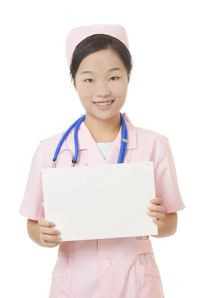 Beautiful Asian nurse holding a blank sign isolated on a white background — Stok fotoğraf