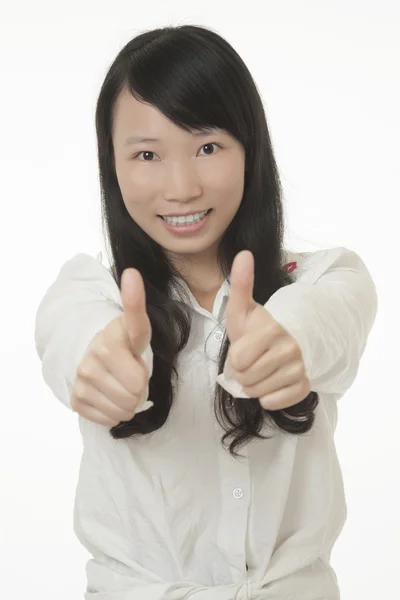 Beautiful Asian woman showing a positive thumbs up isolated on a white background — ストック写真