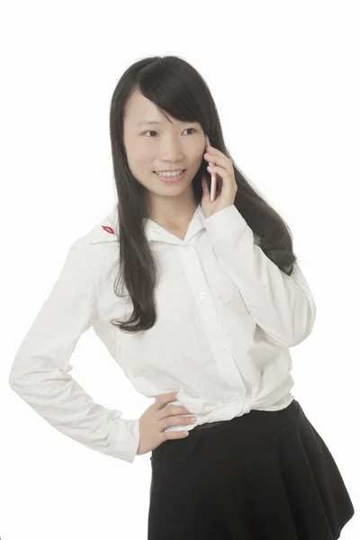 Una hermosa mujer asiática hablando en un teléfono inteligente mientras está aislada sobre un fondo blanco — Foto de Stock