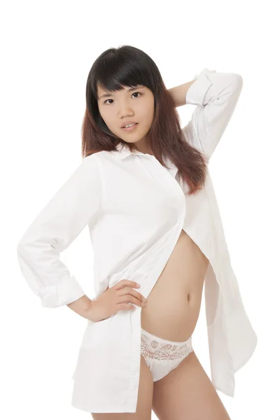 Beautiful and sexy Chinese woman wearing a white shirt and white panties isolated on a white background — Zdjęcie stockowe