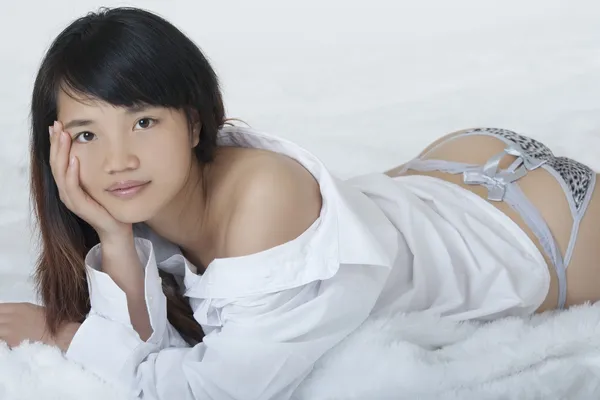 Mulher chinesa bonita e sexy vestindo uma camisa branca isolada em um fundo branco — Fotografia de Stock
