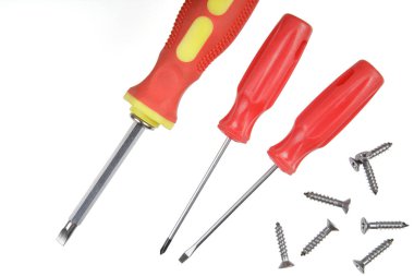 Flat Lay of a close up of screwdrivers and screws isolated on white background