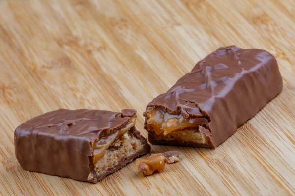 Delicious Chocolate Caramel Bar Isolated Wooden Background —  Fotos de Stock