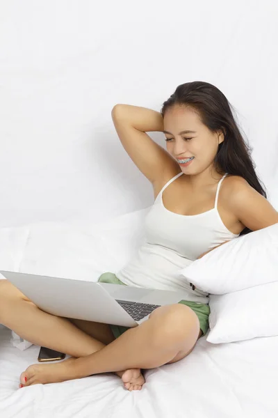 Asian Woman Working Computer Bed Isolated White — Stock Photo, Image