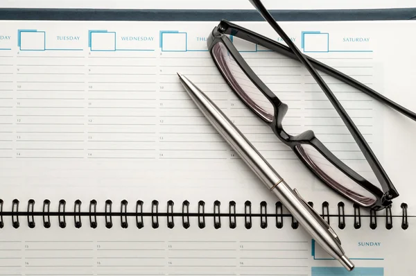 Open weekly planner with ballpen. — Stock Photo, Image