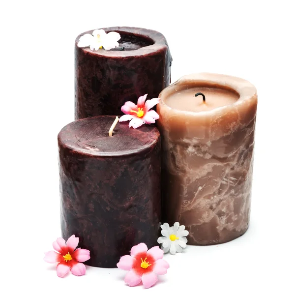 Três velas e flores . Imagem De Stock