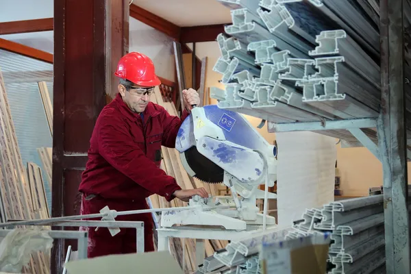 Worker Cutting PVC Profile with Circular Saw — Stock Photo, Image