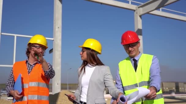 Mixed Construction Team Hardhats Walking Slow Motion Discuss Project Site — Stock Video