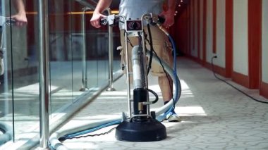Hand Push Washing Machine For Hotel Carpet Cleaning. Cleaner Male Worker With Carpet Cleaning Machine Cleaning Hotel Corridor Carpet. Cleaning And Maintenance Of Hospitality Carpet.