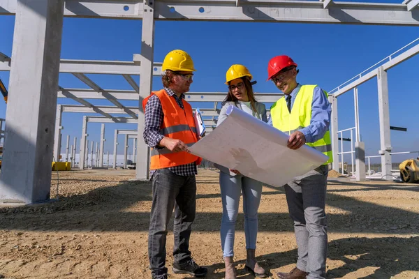 Industrial And Factory Construction And Project Management. Supervisor, Female Architect And Construction Foreman Having Conversation At Workplace. Project Management And Field Crew Meeting.