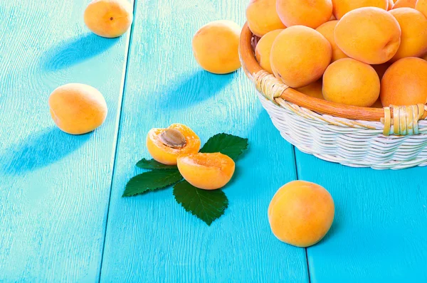 Juicy apricots on a turquoise background — Stock Photo, Image